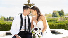 Bride and groom sitting close together, touching foreheads and holding a bouquet, a romantic moment captured by affordable wedding photographers in Columbus, Ohio.