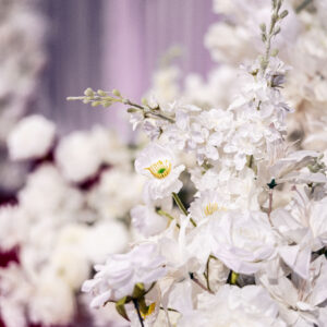 Elegant white floral arrangement with roses and delicate blossoms creating a serene and sophisticated ambiance perfect for weddings and special occasions.