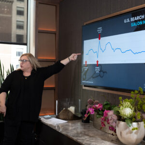 Corporate event photo showing a speaker presenting search trend insights to attendees