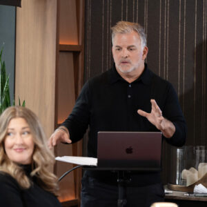 Presenter speaking to attendees during a corporate meeting.