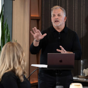 Business professional giving a presentation in a modern meeting room.