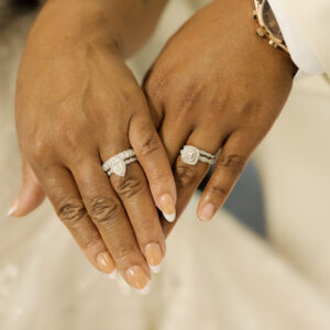 Close-up of a couple's hands showcasing elegant wedding and engagement rings with detailed diamond settings symbolizing love commitment and special occasions marital unity.