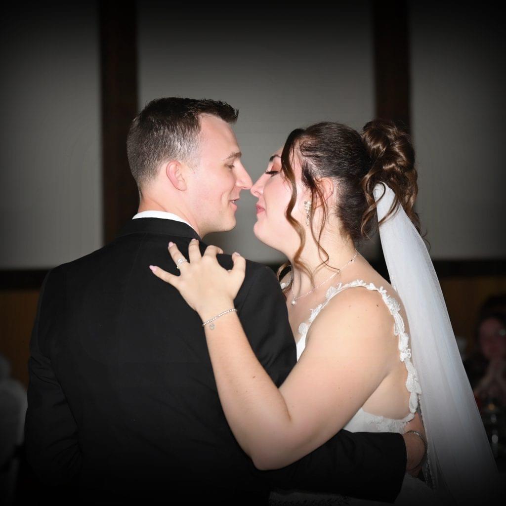 Home Page 11 Bride and groom sharing their first dance, smiling and embracing, beautifully captured by one of the best wedding photographers in Ohio, offering affordable photography in Columbus, Ohio.